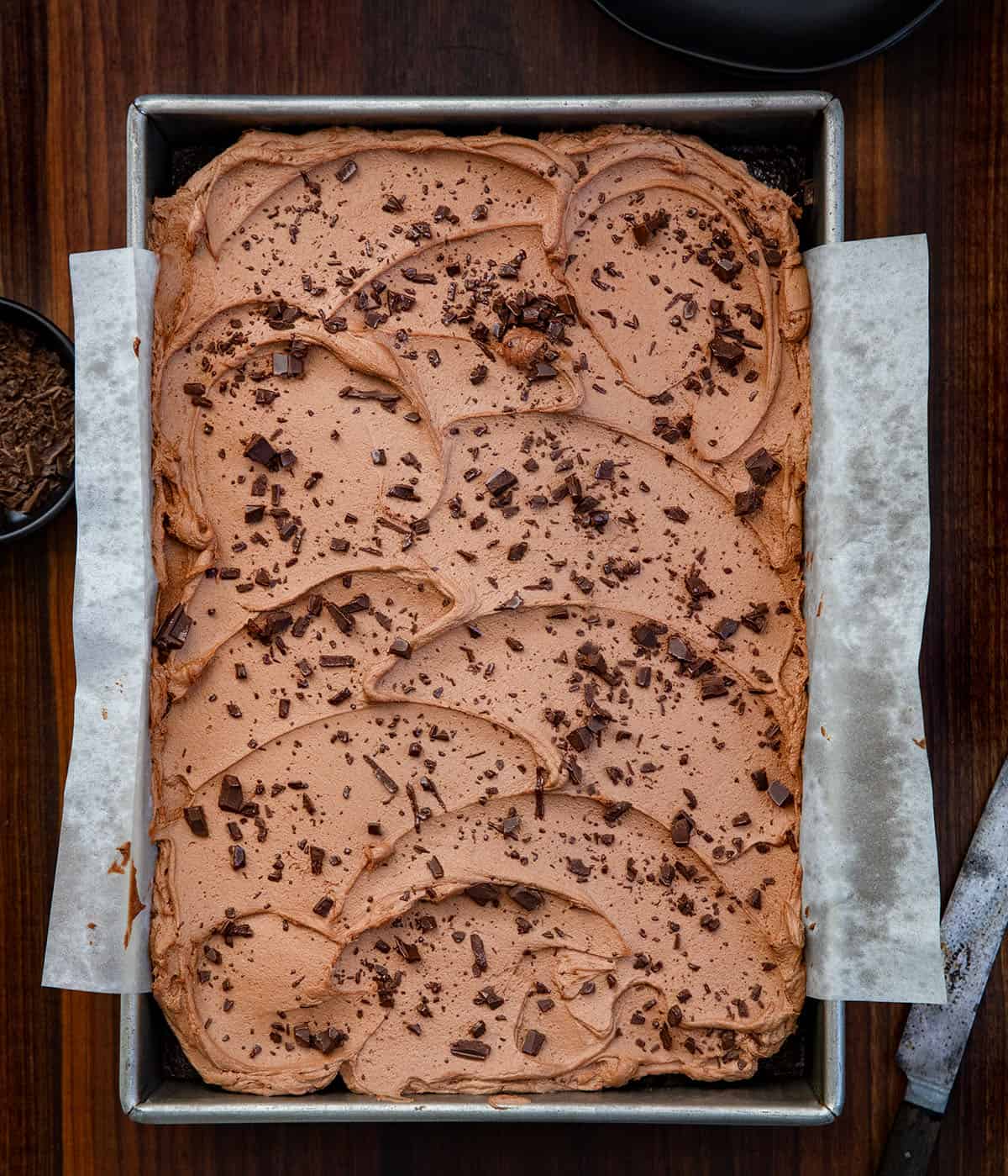 Chocolate Sheet Cake in a 9x13 pan on a wooden table from overhead.
