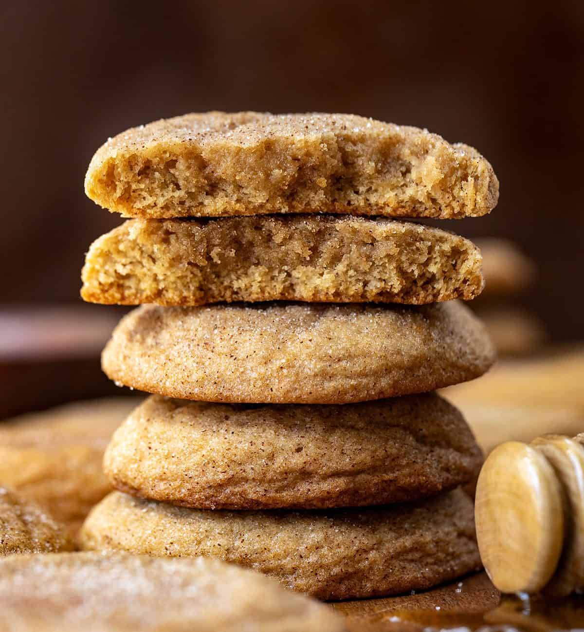 Stack of Honey Snickerdoodles with the top cookie halved showing inside texture.