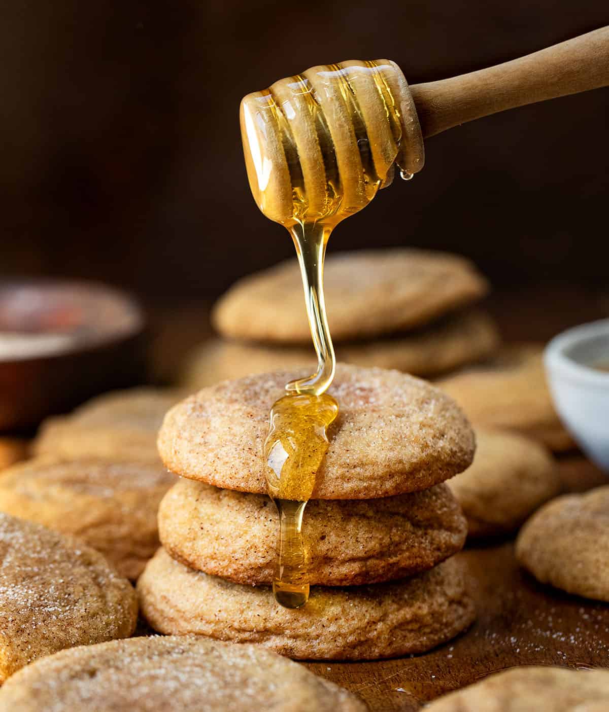 Drizzling honey over a stack of Honey Snickerdoodles.