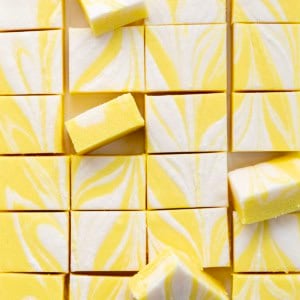 Lemon Creamsicle Fudge cut into squares with some on their sides.