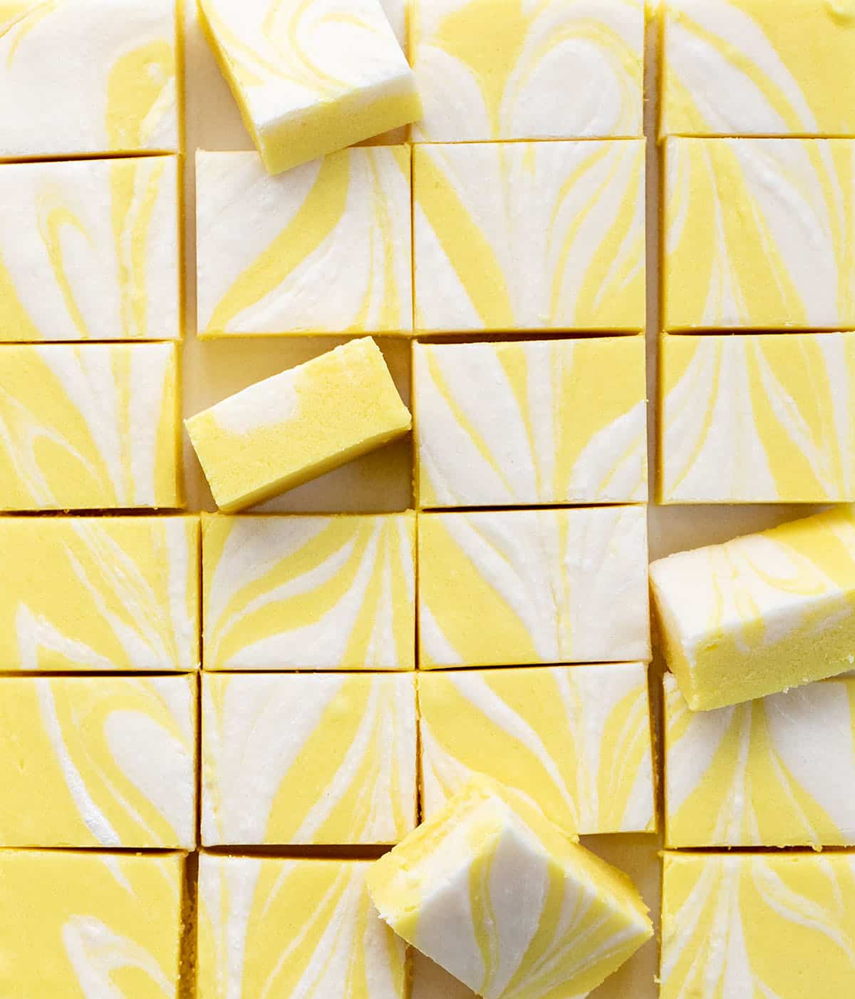 Lemon Creamsicle Fudge cut into squares with some on their sides.