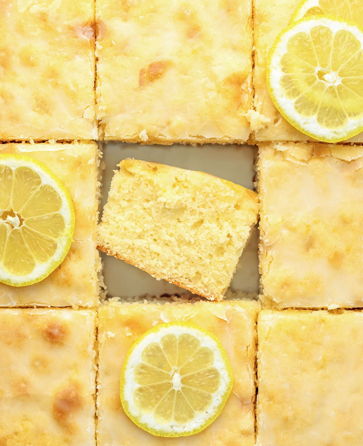 Cut up Lemon Sheet Cake with the center piece on its side.