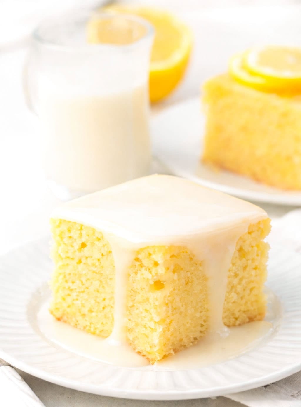 Piee of Lemon Sheet Cake with glaze on it.