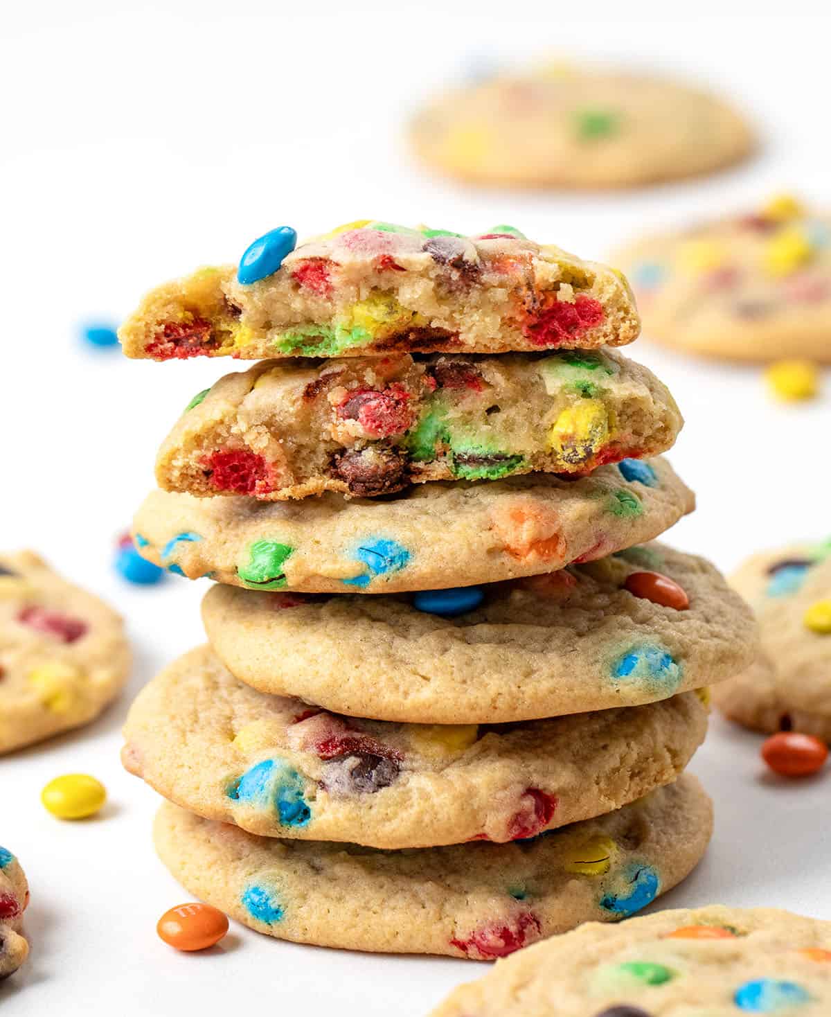 Stack of Mini M&M Cookies with he top cookie broken in half.