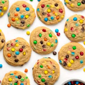 Mini M&M Cookies on a white table from overhead.