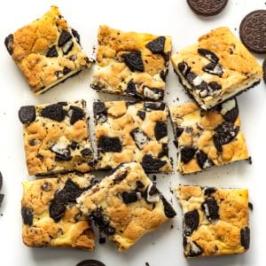 Oreo Chocolate Chip Cheesecake Bars on a white table from overhead.