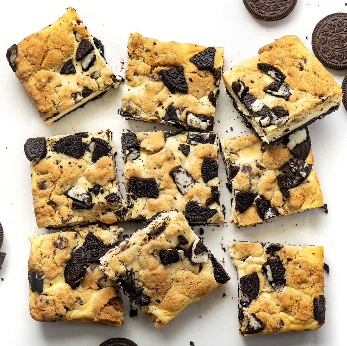 Oreo Chocolate Chip Cheesecake Bars on a white table from overhead.