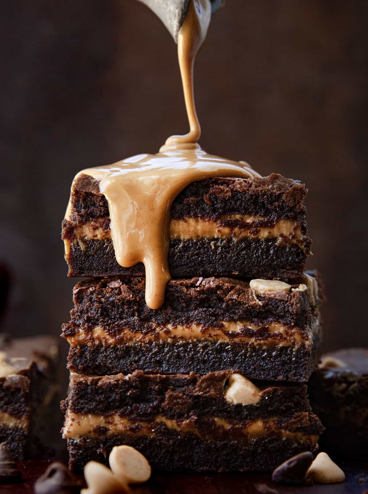 Drizzling peanut butter over Peanut Butter Stuffed Brownies.