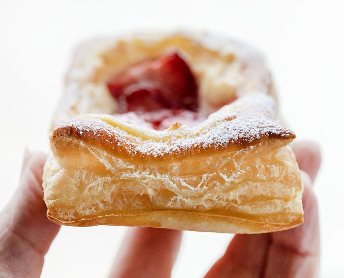 Hand holding a Strawberry Cream Cheese Danish.