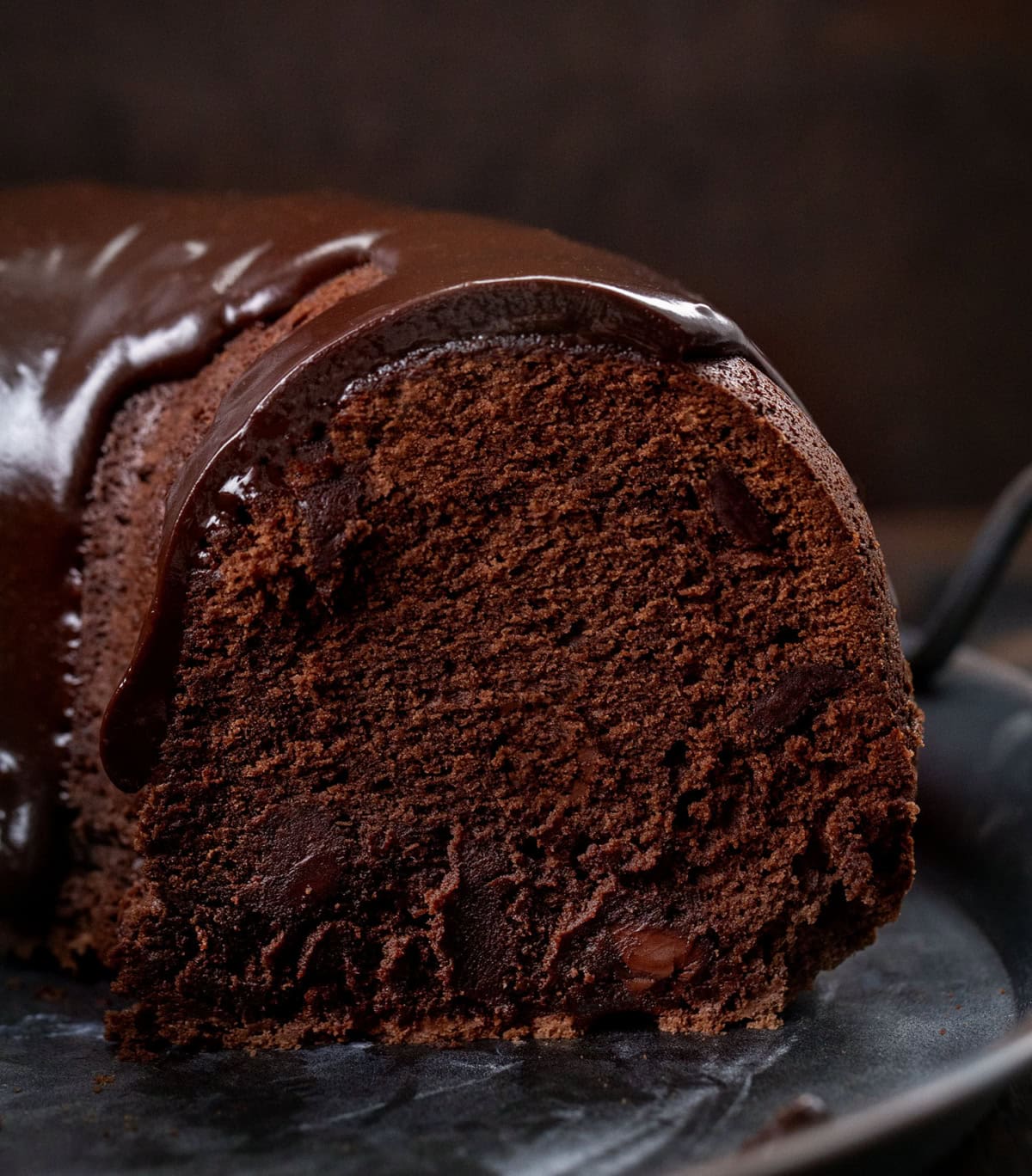Close up of a cut into Triple Chocolate Pound Cake showing the tender crumb and extra chocolate.