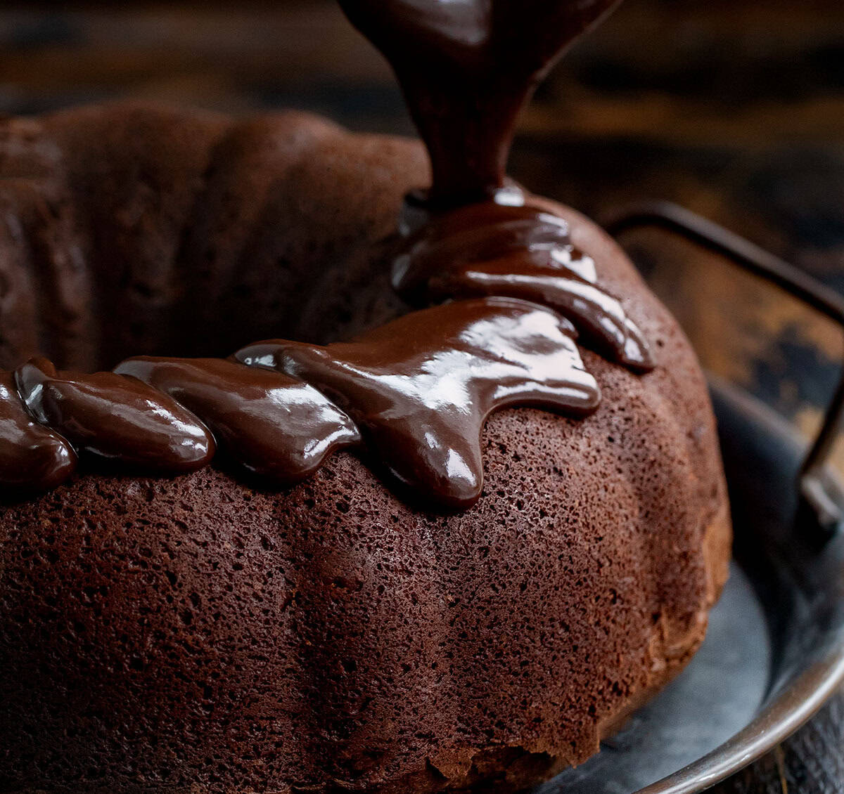 Drizzling ganache over a Triple Chocolate Pound Cake.