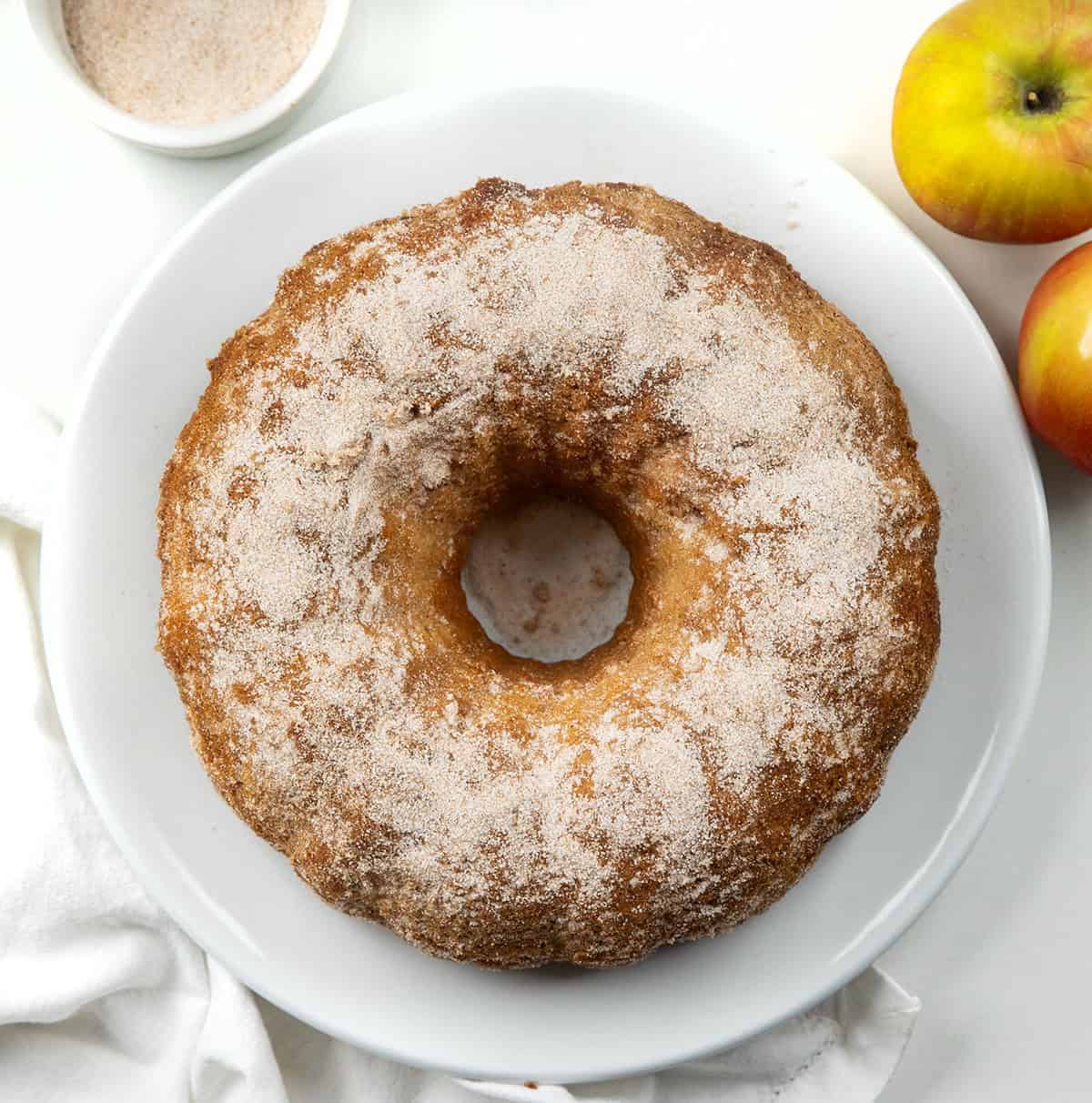 Apple Cider Donut Bundt Cake on a white table from overhead.