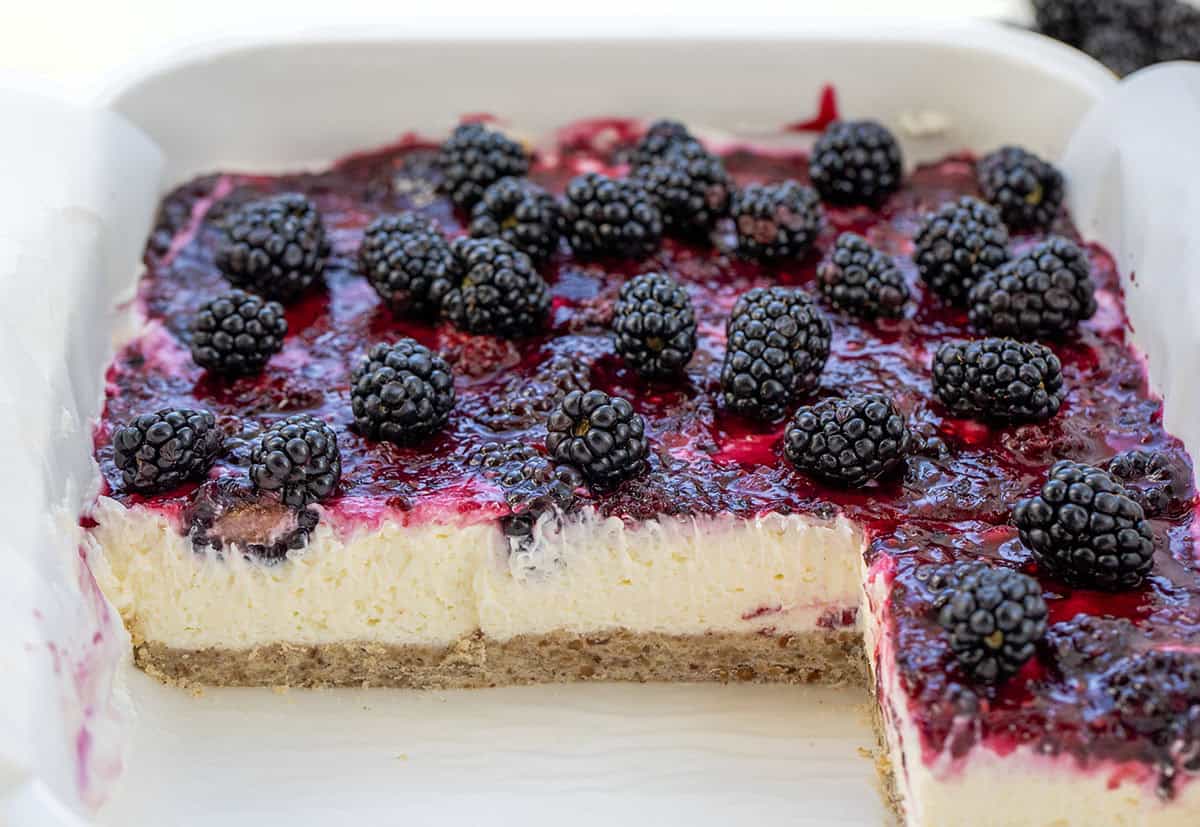 Pan of Blackberry Cream Cheese Bars with some bars missing.