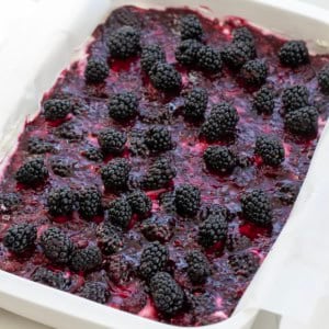 White pan of Blackberry Cream Cheese Bars close up.