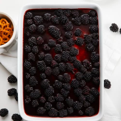 Pan of Blackberry Pretzel Salad on a white table from overhead.