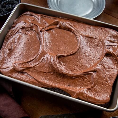 Pan of Devil's Food Sheet Cake on a wooden table.