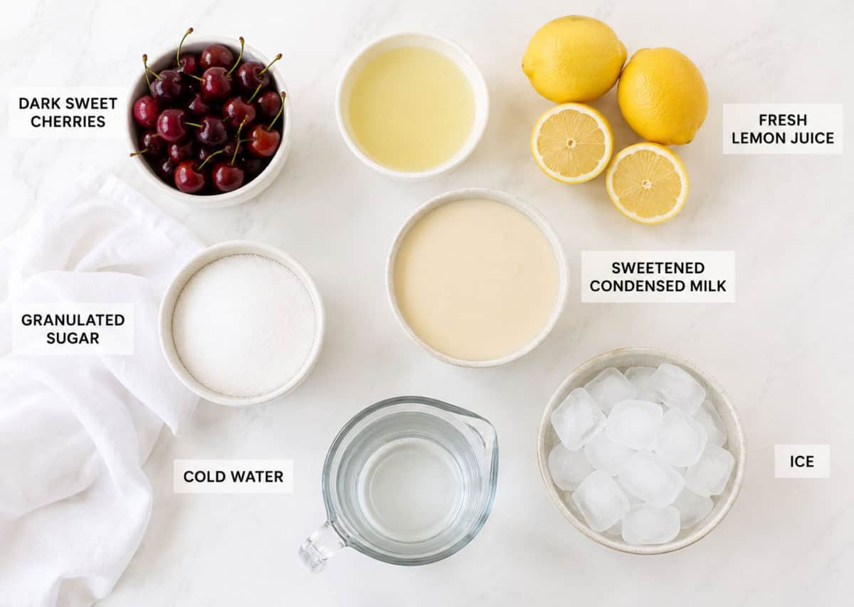 Ingredients for Creamy Cherry Lemonade- cherries, lemon, sweetened condensed milk, sugar, water, and ice.