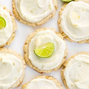 Key Lime Cookies on a white table with half moon key limes.