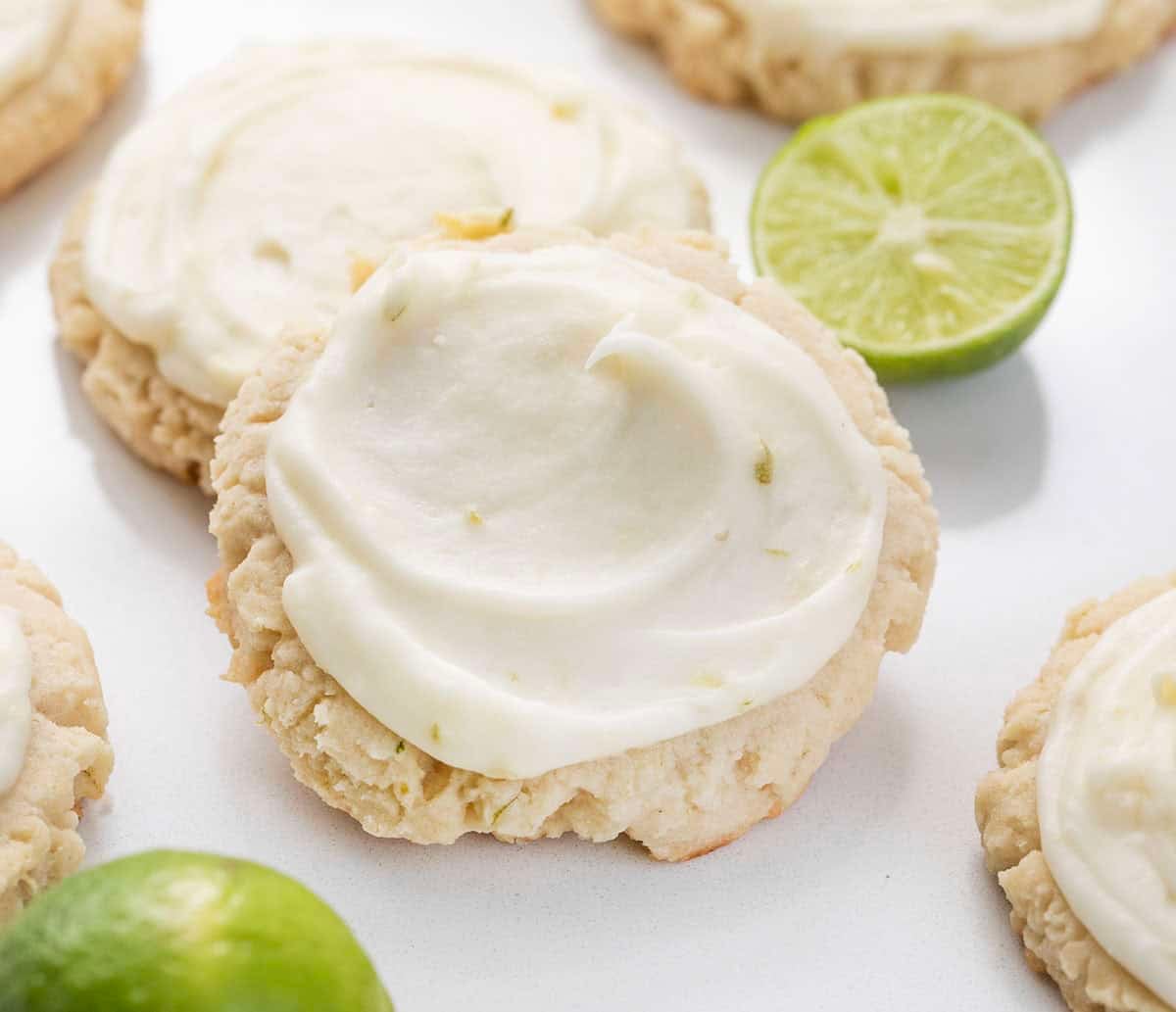 Close up of frosted Key Lime Cookies on a white table.