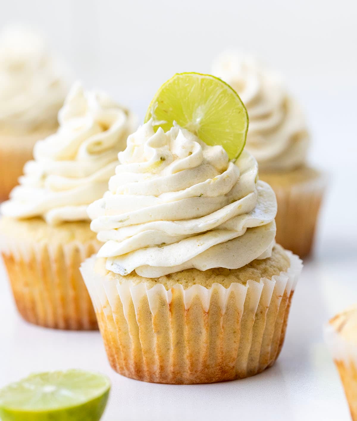 Key Lime Cupcakes with Key Lime Ermine and a fresh lime slice in the frosting.