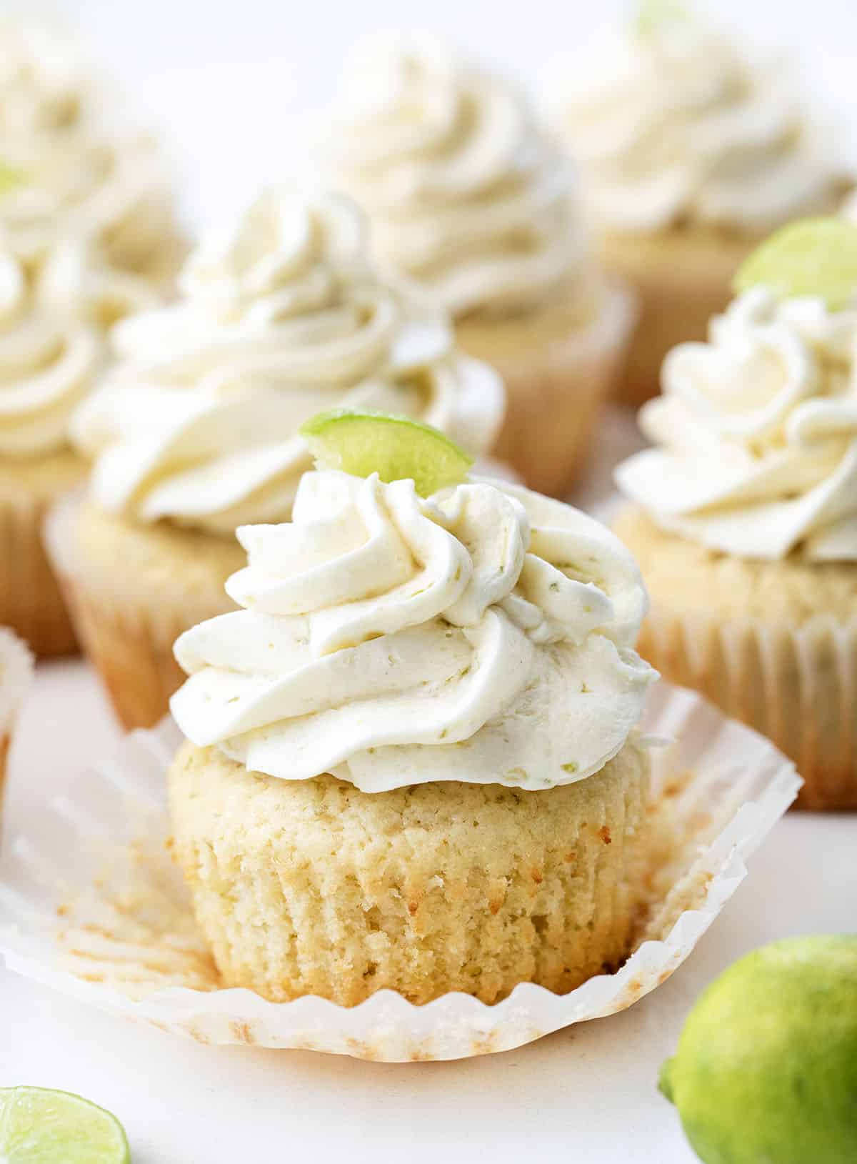 Key Lime Cupcakes with the front cupcake wrapper peeled away from the cupcake.
