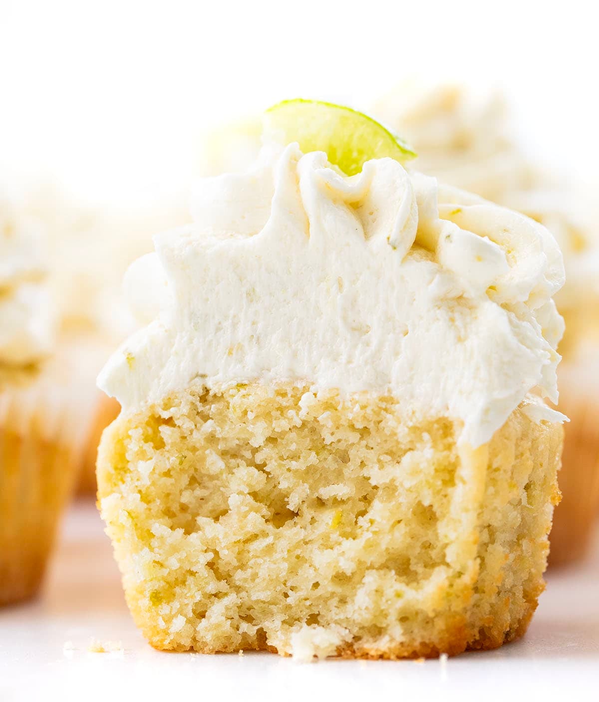 Close up of a Key Lime Cupcake that has been halved showing the inside texture.