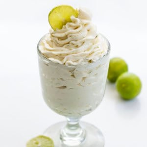 Glass of Key Lime Ermine Frosting with fresh key limes.