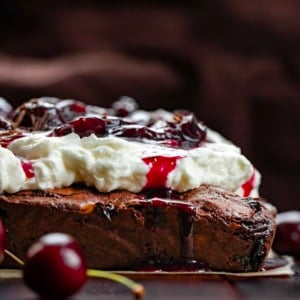 Close up of Black Forest Brownies on a wooden table.