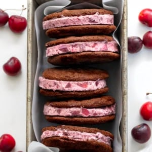 Chocolate Cherry Ice Cream Sandwiches in a pan on a white table.