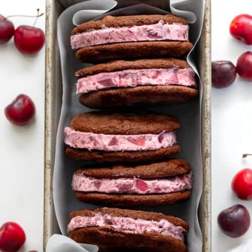 Chocolate Cherry Ice Cream Sandwiches in a pan on a white table.