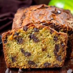 Loaf of Chocolate Chip Zucchini Bread with one slice cut and leaning against the loaf.
