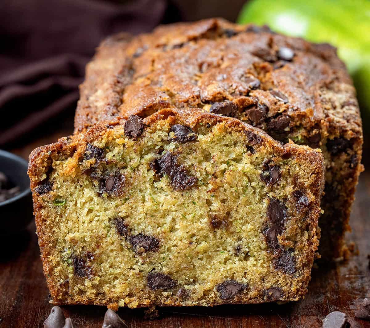 Loaf of Chocolate Chip Zucchini Bread with one slice cut and leaning against the loaf.