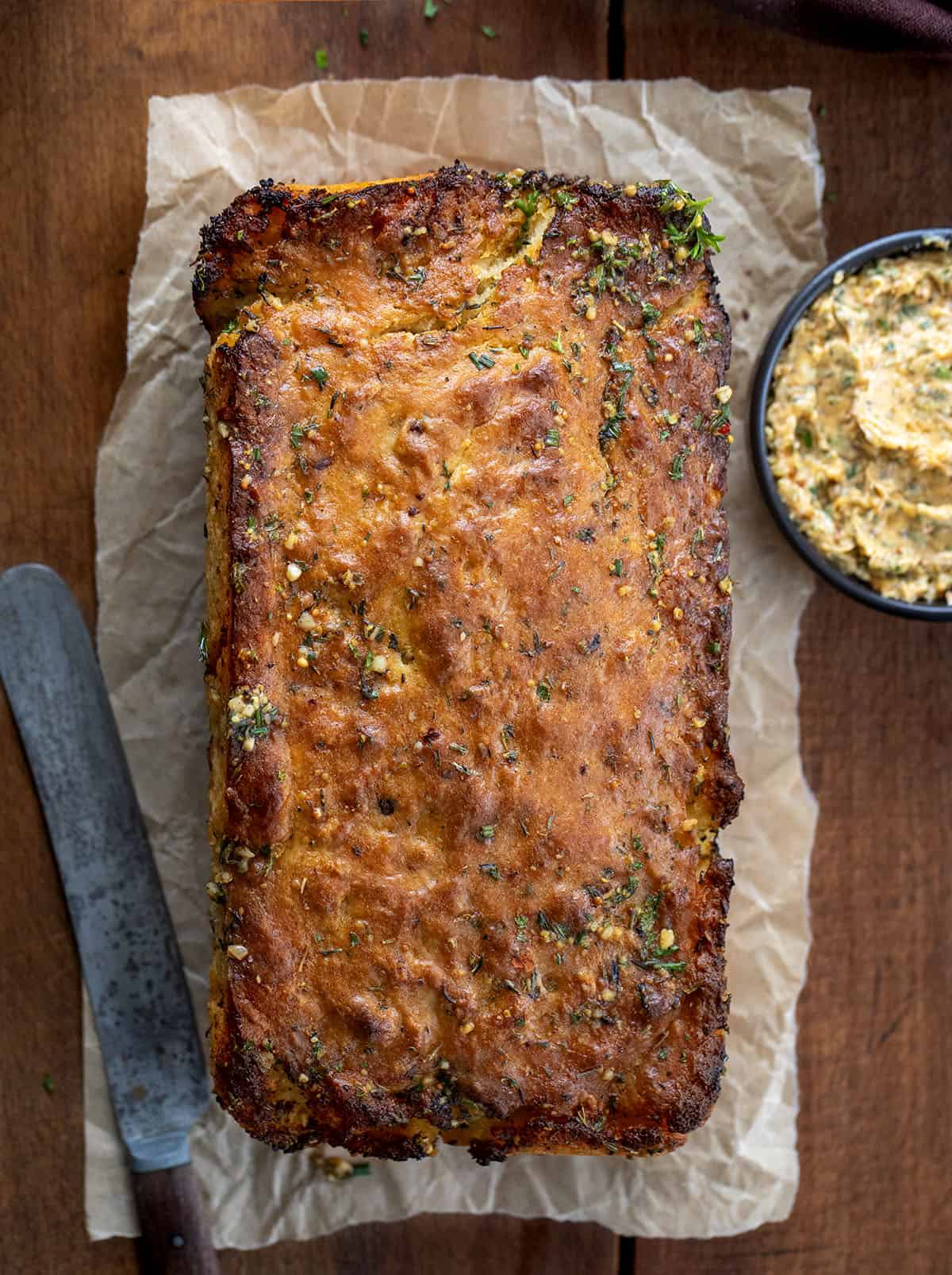 Loaf of Cowboy Butter Swim Bread on a wooden table from overhead.
