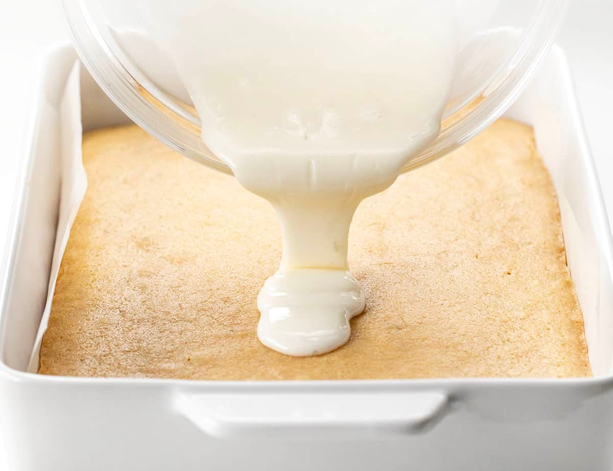 These Lime Brownies are soft, chewy, and bursting with fresh citrus flavor in every bite. Made with brown sugar for a blondie-like texture and finished with a sweet-tart lime glaze, theyโre the perfect balance of rich and refreshing! Pouring lime glaze over Lime Brownies.