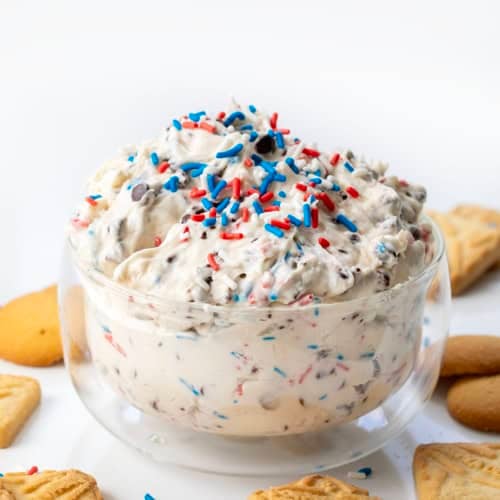 Glass bowl filled with Patriotic Booty Dip, or Patriotic Chocolate Chip Dip.
