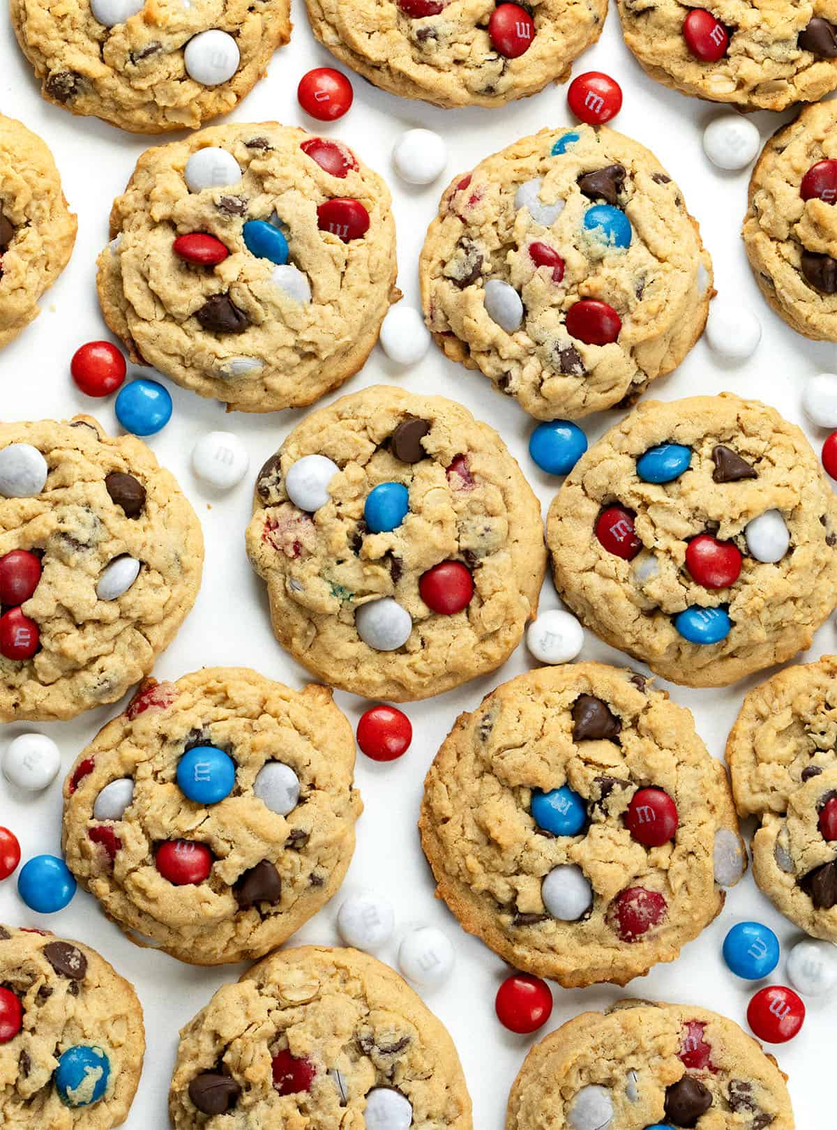 Patriotic Monster Cookies on a white table from overhead.