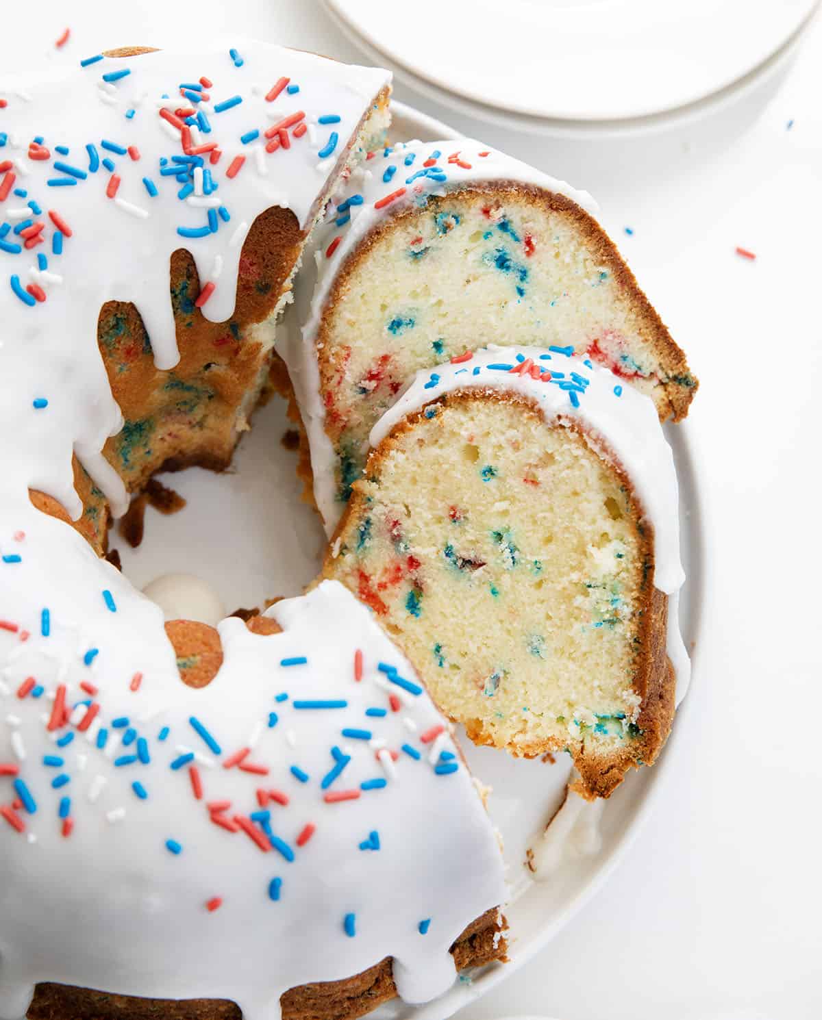 Cut into Red, White, and Blue Pound Cake showing tender crumb and bursts of red and blue.