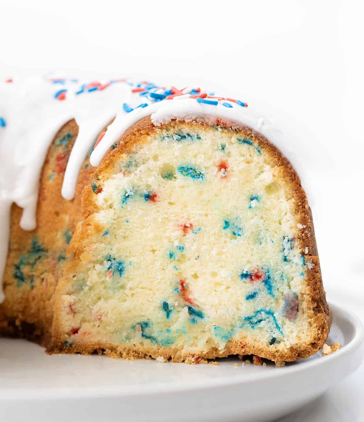 Cut into Red, White, and Blue Pound Cake showing tender crumb and bursts of red and blue.
