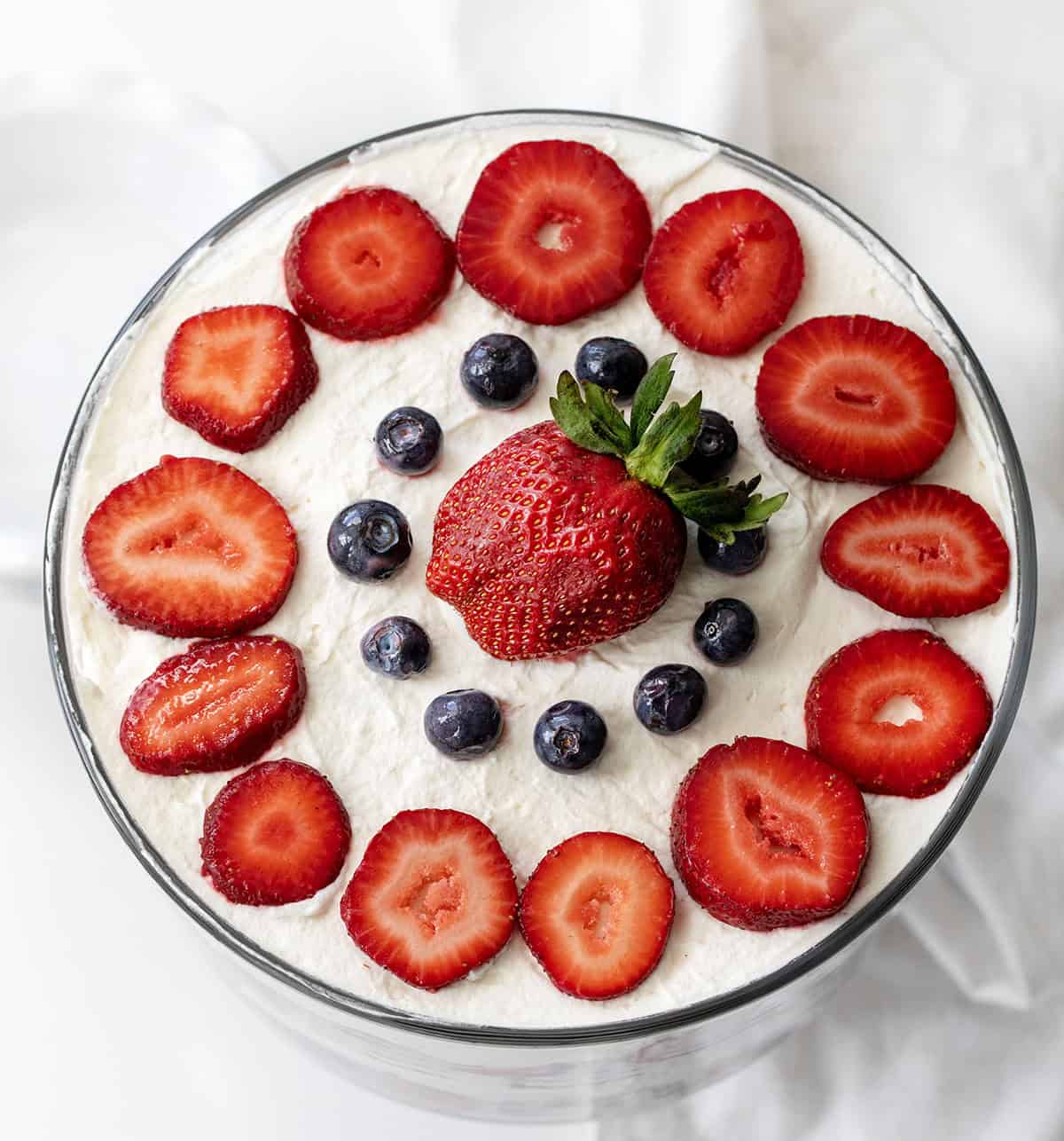 Layered Red Velvet Berry Trifle with Fresh Berries and Whipped Cream Looking down on a Red Velvet Berry Trifle showing fresh cut strawberries and blueberries.