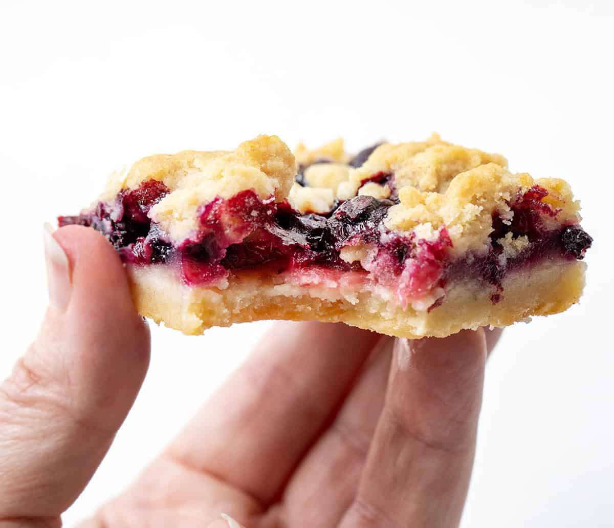Hand holding a Strawberry Blueberry Crumble Bar.