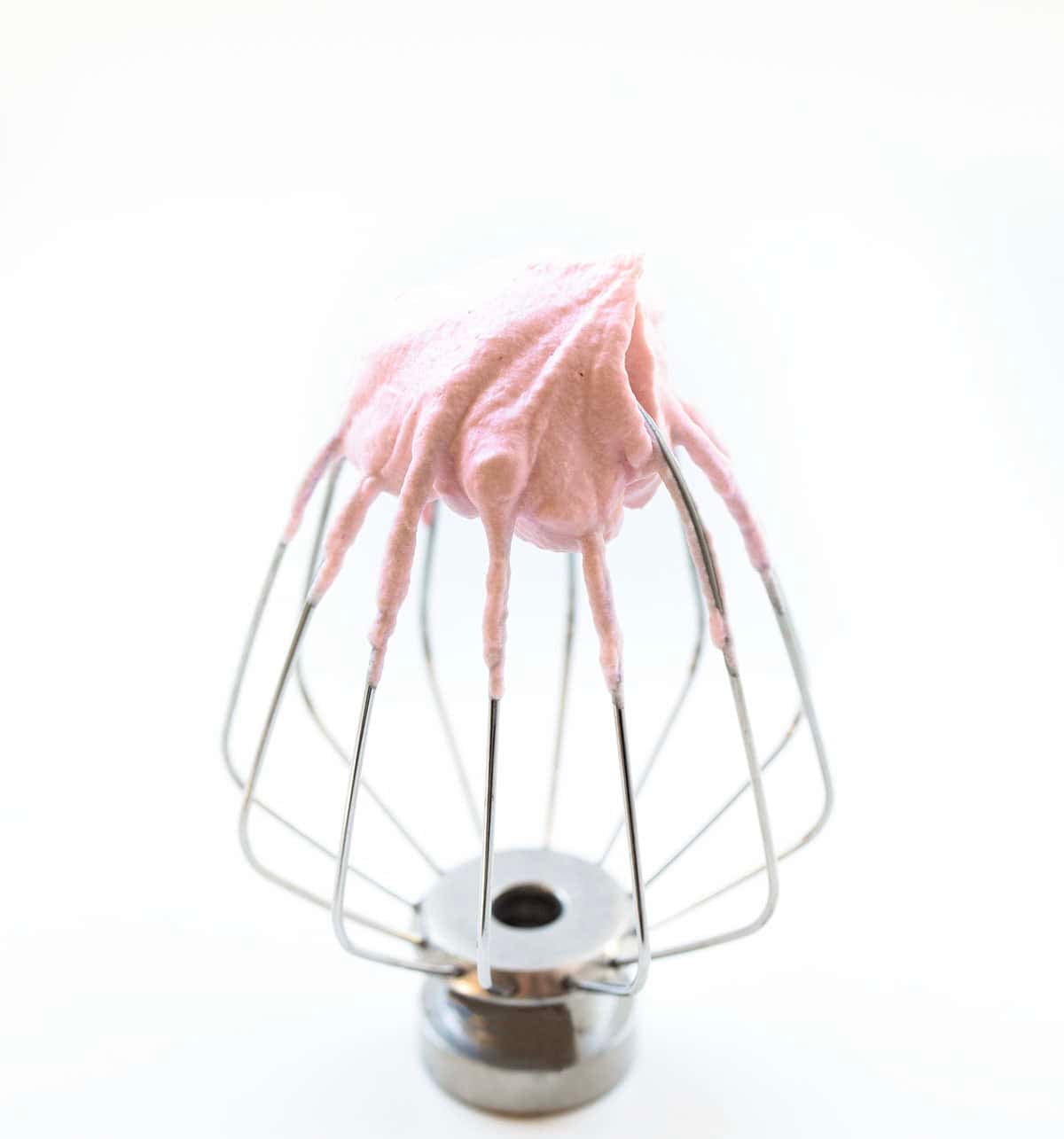 Strawberry Stabilized Whipped Cream on a whisk.