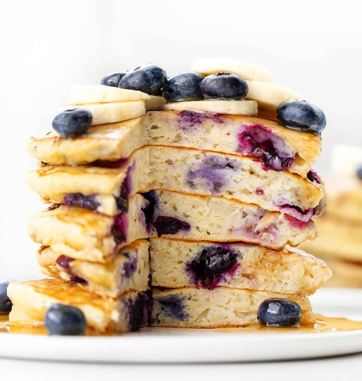 Stack of cut into Blueberry Banana Buttermilk Pancakes close up.