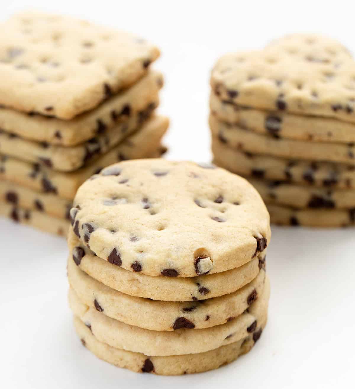 Stacks of circles, hearts, and squares of Chocolate Chip Cut-Out Cookies.