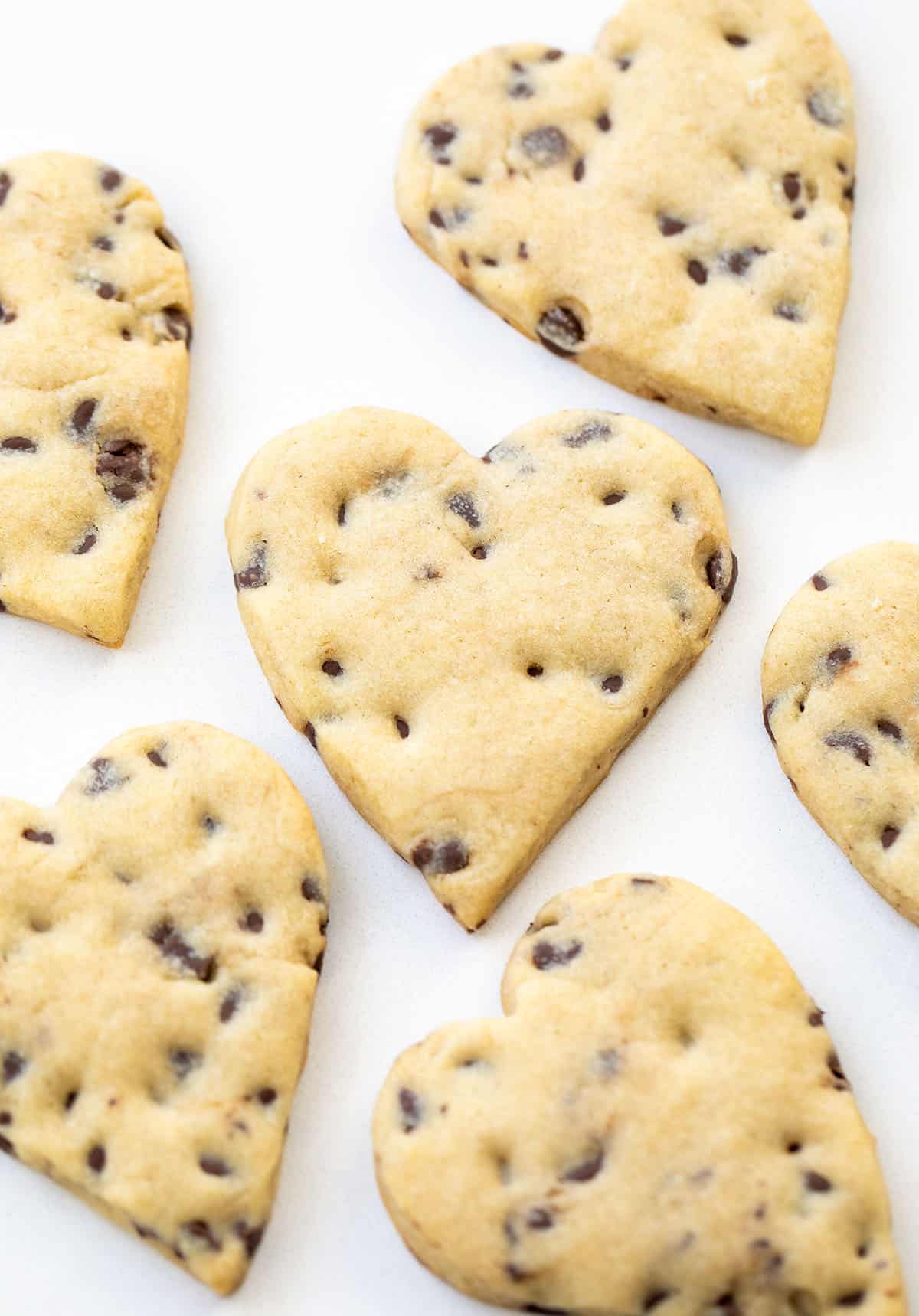 Heart Chocolate Chip Cut-Out Cookies on a white table Heart Chocolate Chip Cut-Out Cookies on a white table.