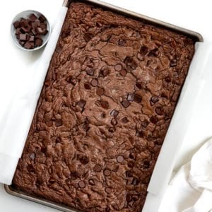 Pan of Double Chocolate Sheet Pan Cookies on a white table from overhead.