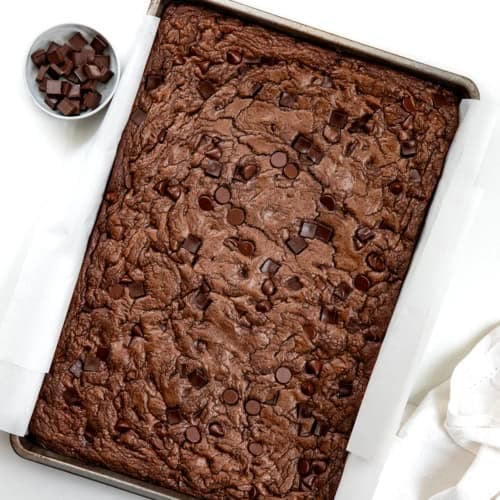 Pan of Double Chocolate Sheet Pan Cookies on a white table from overhead.