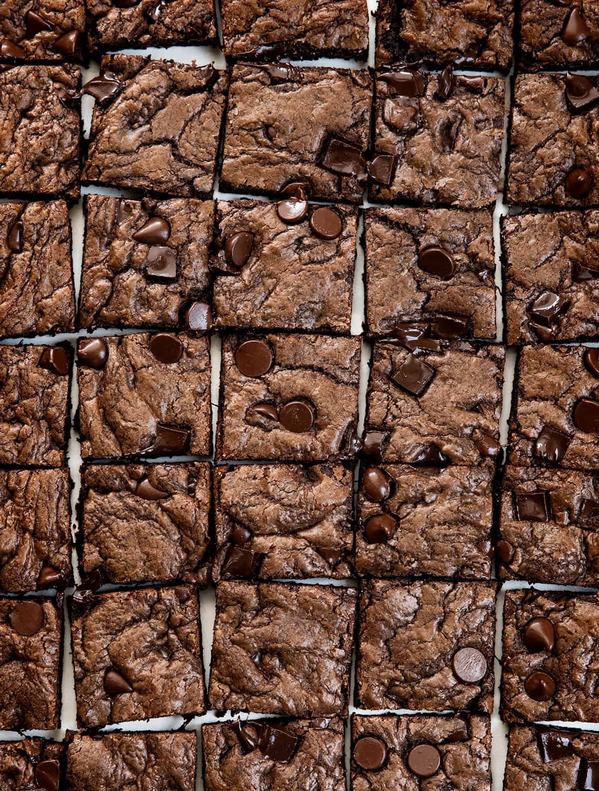 Double Chocolate Sheet Pan Cookies cut into squares on a white table from overhead.