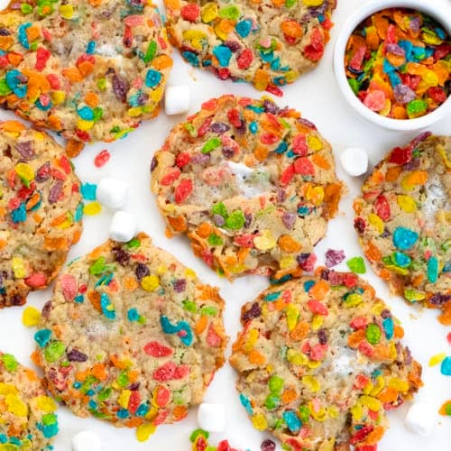 Fruity Pebbles Cookies laid out on a white table from overhead.