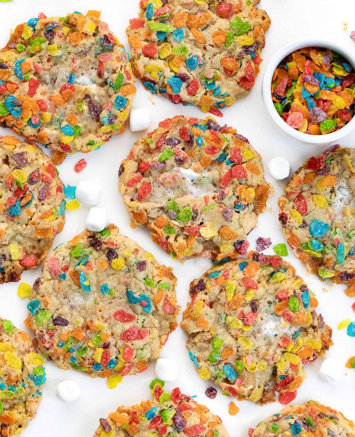 Fruity Pebbles Cookies laid out on a white table from overhead Fruity Pebbles Cookies laid out on a white table from overhead.