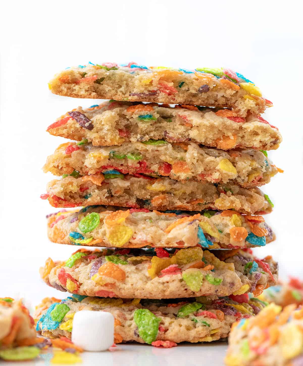 Stack of Fruity Pebbles Cookies with the top cookies halved showing inside texture Stack of Fruity Pebbles Cookies with the top cookies halved showing inside texture.